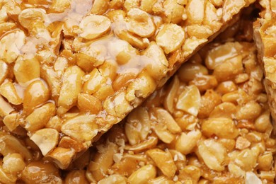 Photo of Delicious peanut bars (kozinaki) as background, closeup