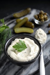 Photo of Tasty tartar sauce on marble board, closeup