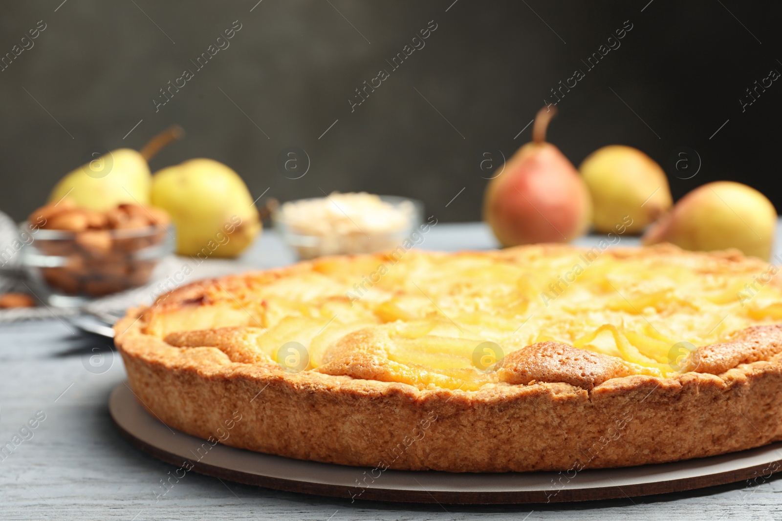 Photo of Delicious sweet pear tart on grey wooden table
