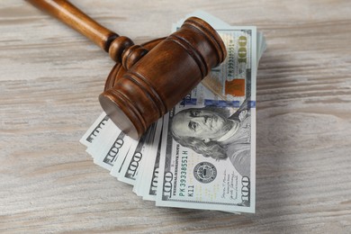 Judge's gavel and money on wooden table