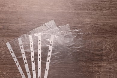 Punched pockets on wooden table, flat lay