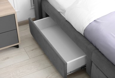 Storage drawer for bedding under modern bed in room