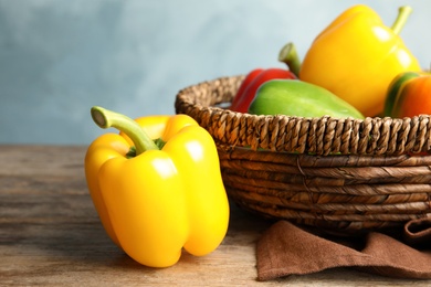 Photo of Raw ripe paprika peppers on wooden table