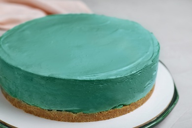 Delicious homemade spirulina cheesecake on light table