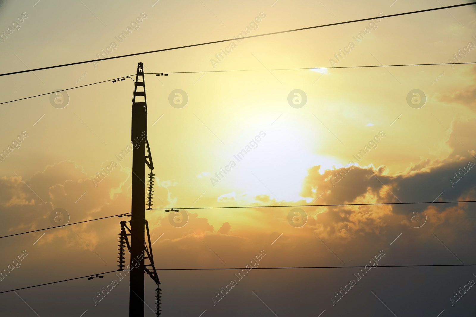 Photo of Silhouette of telephone pole with cables on sunny day