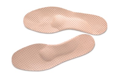 Beige orthopedic insoles isolated on white, top view