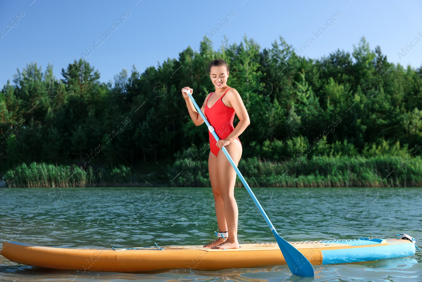 Photo of Woman paddle boarding on SUP board in river