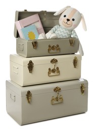 Stylish storage trunks with child's accessories and dog toy on white background. Interior elements