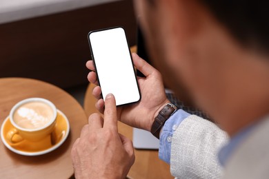 Photo of Man using his smartphone in cafe, closeup