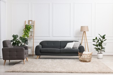 Photo of Beautiful room with stylish furniture and houseplants