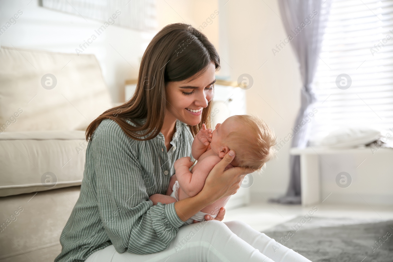 Photo of Mother with her newborn baby at home