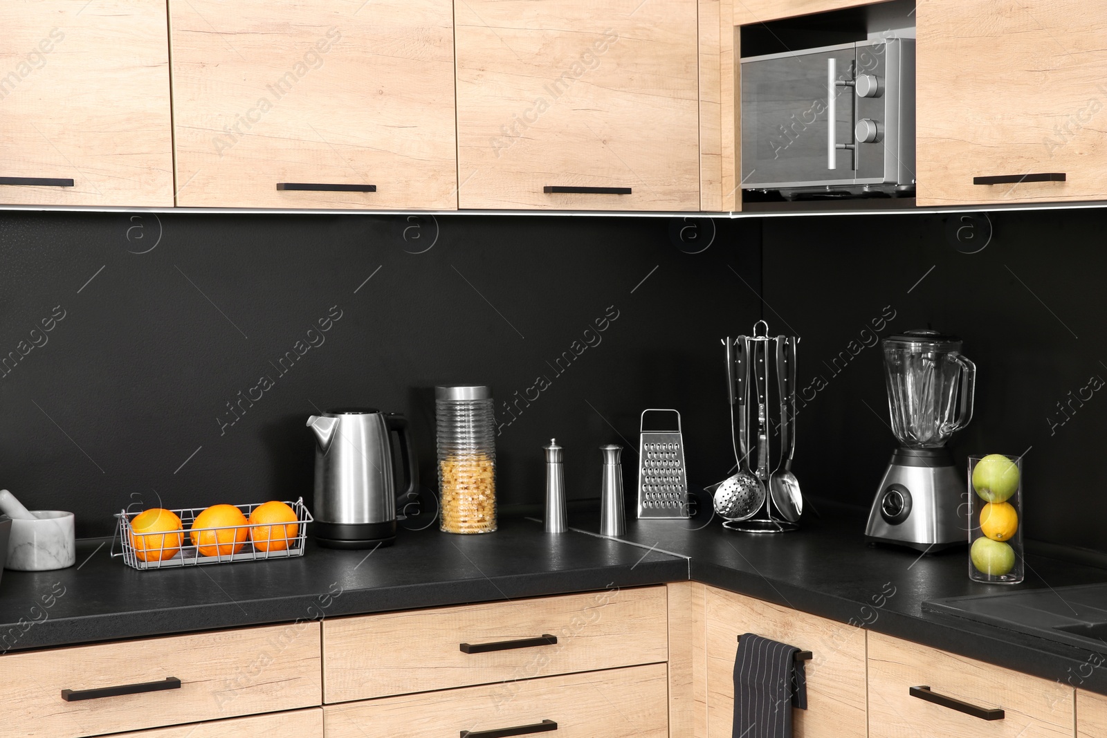 Photo of Stylish kitchen counter with houseware, appliances and products