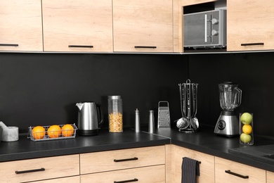 Photo of Stylish kitchen counter with houseware, appliances and products