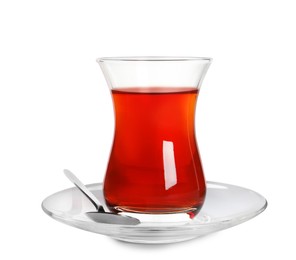 Photo of Glass of traditional Turkish tea with spoon isolated on white