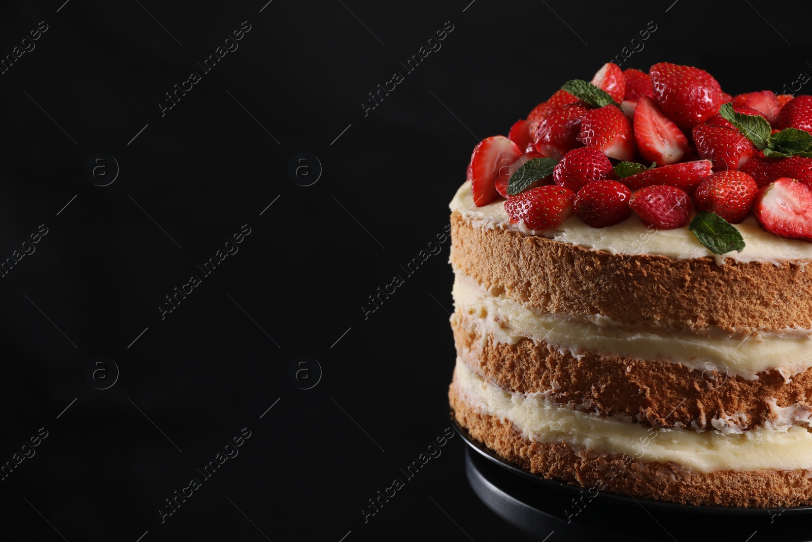 Photo of Tasty cake with fresh strawberries and mint on black background, closeup. Space for text