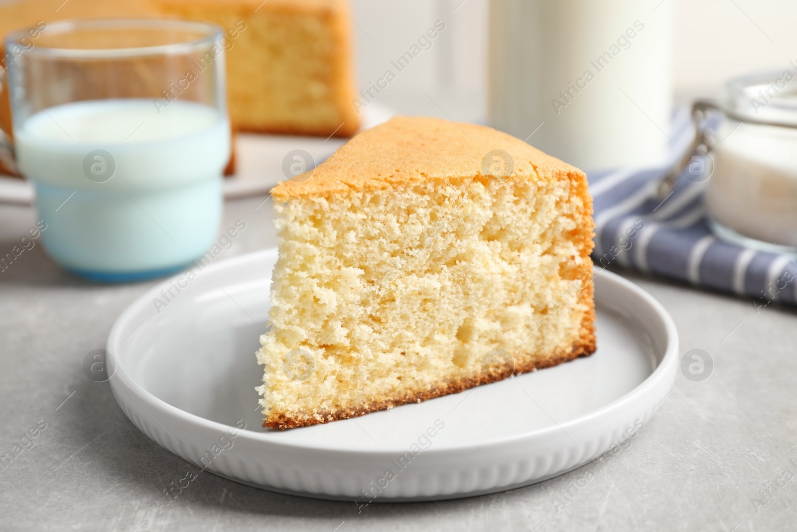 Photo of Piece of delicious fresh homemade cake on light grey marble table