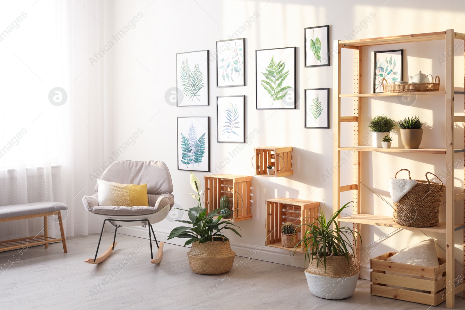 Photo of Beautiful paintings of tropical leaves on white wall in living room interior