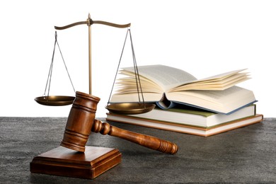 Photo of Law concept. Judge's mallet, scales of justice and books on dark grey table against white background