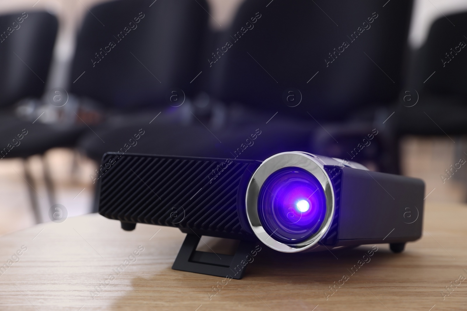 Photo of Modern video projector on table in conference room