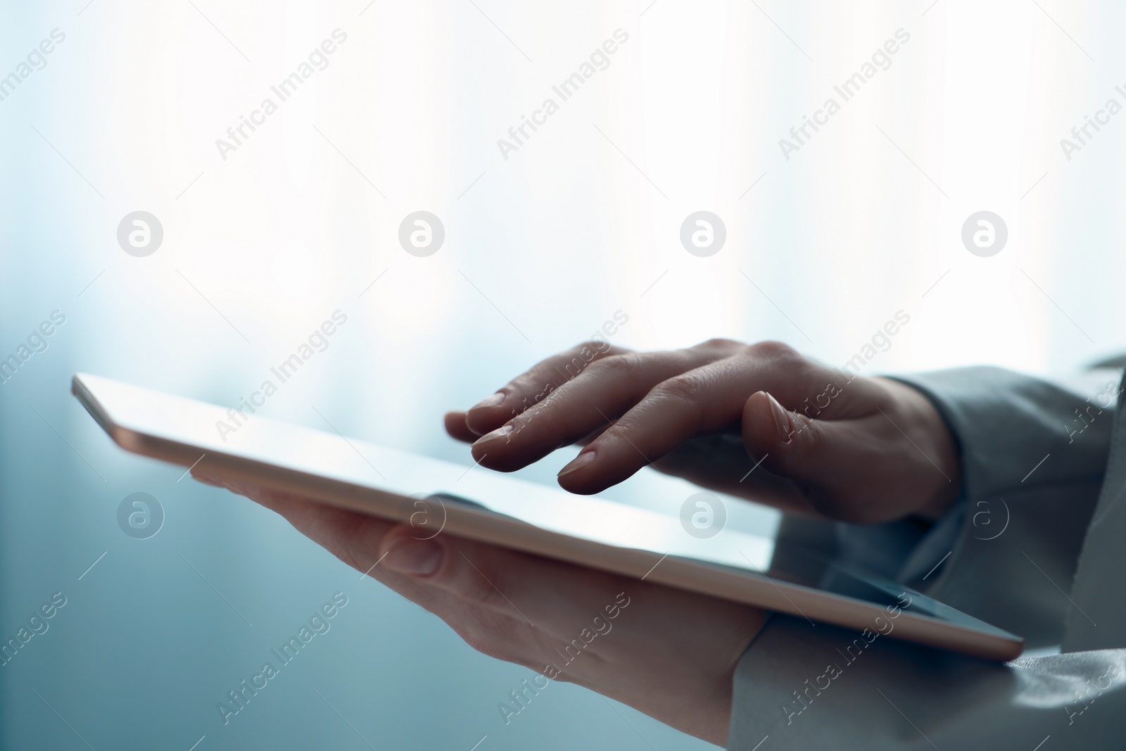 Photo of Closeup view of woman using modern tablet on blurred background