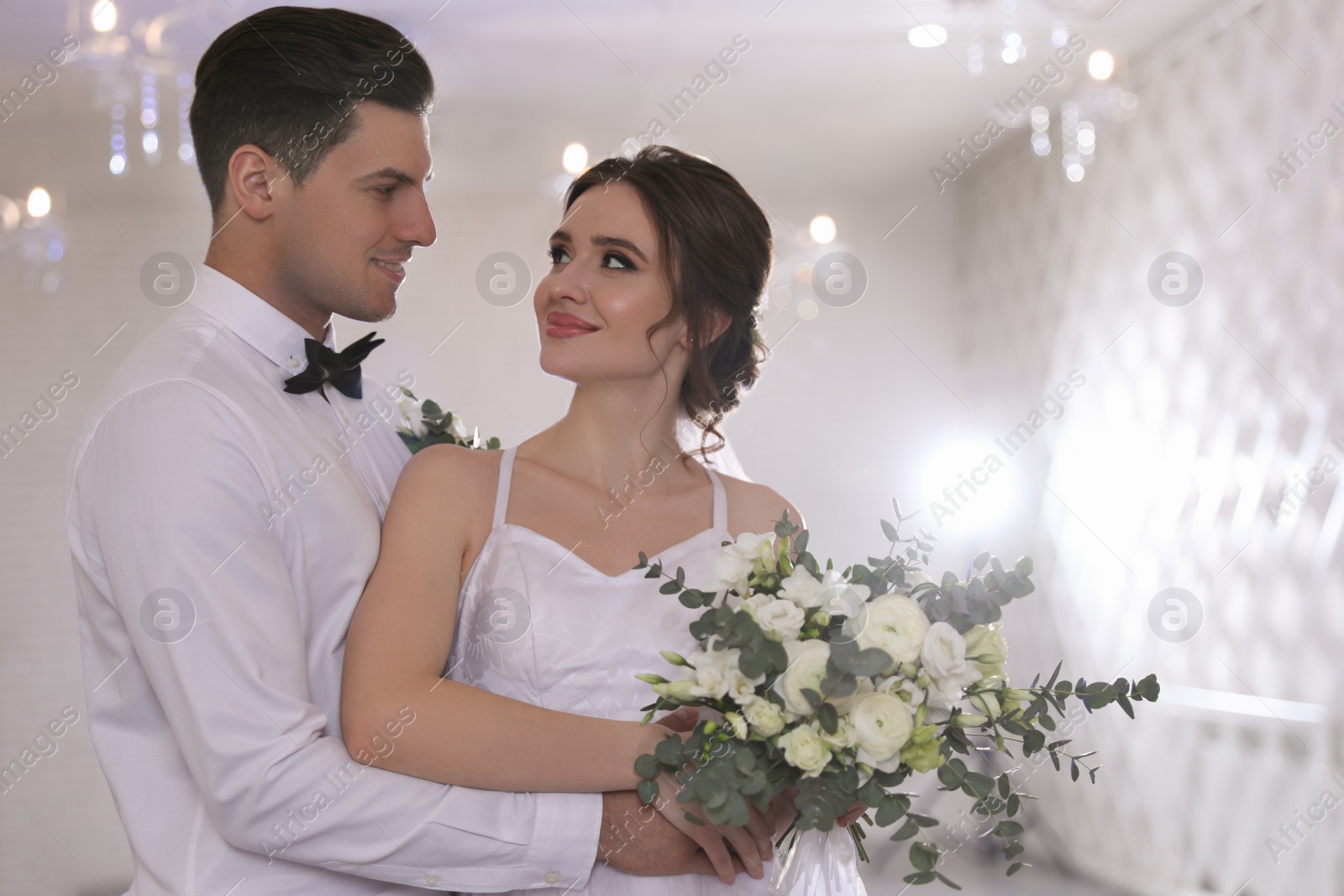 Photo of Happy newlywed couple together in festive hall