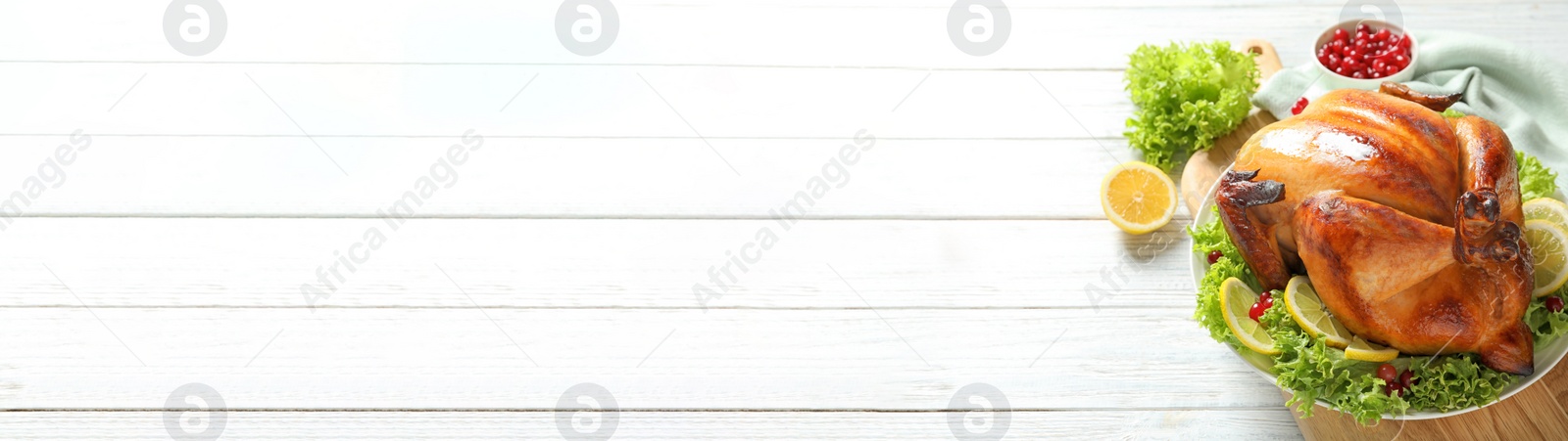 Image of Delicious roasted turkey served on white wooden table, space for text. Banner design