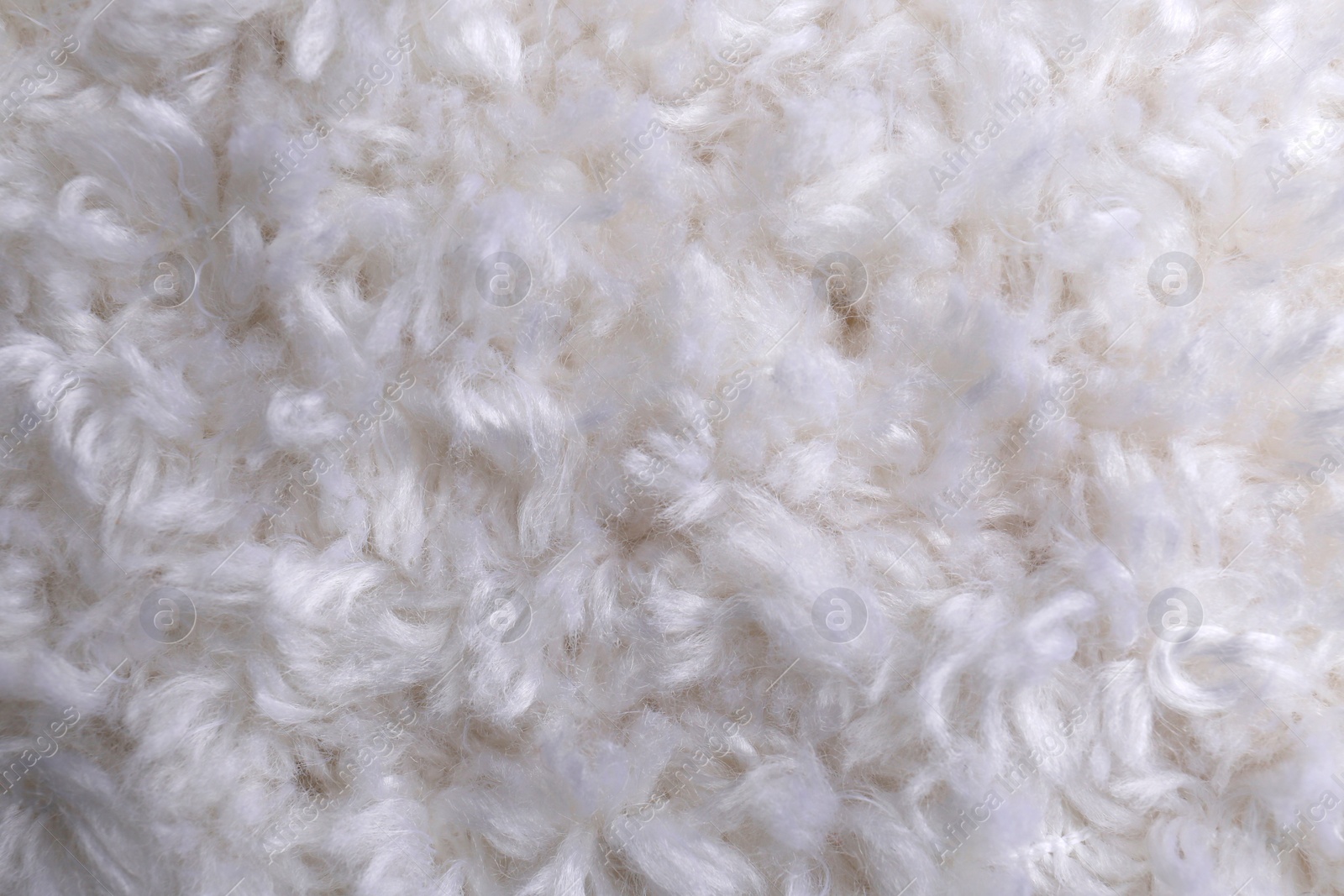 Photo of Soft white knitted fabric as background, top view