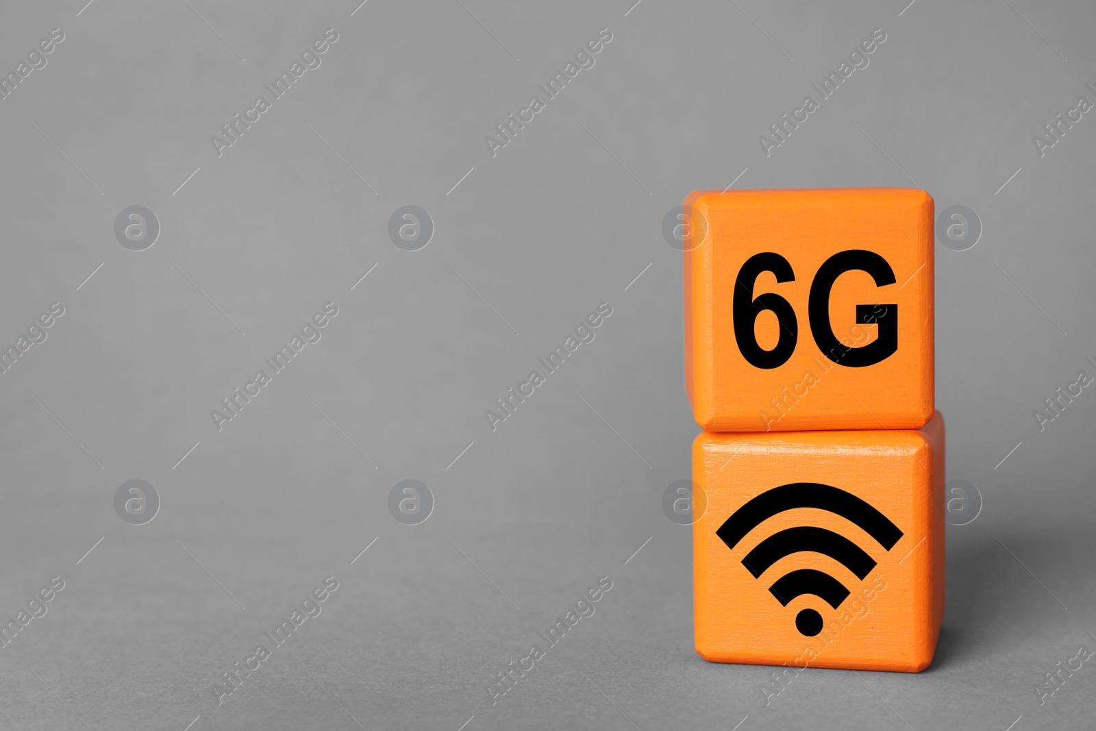 Photo of 6G technology, Internet concept. Orange wooden cubes on light grey background, space for text