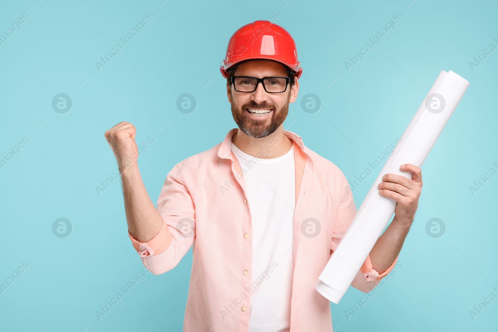 Photo of Architect in hard hat with draft on light blue background