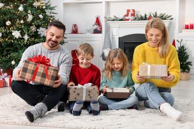 Photo of Happy family with Christmas gifts at home