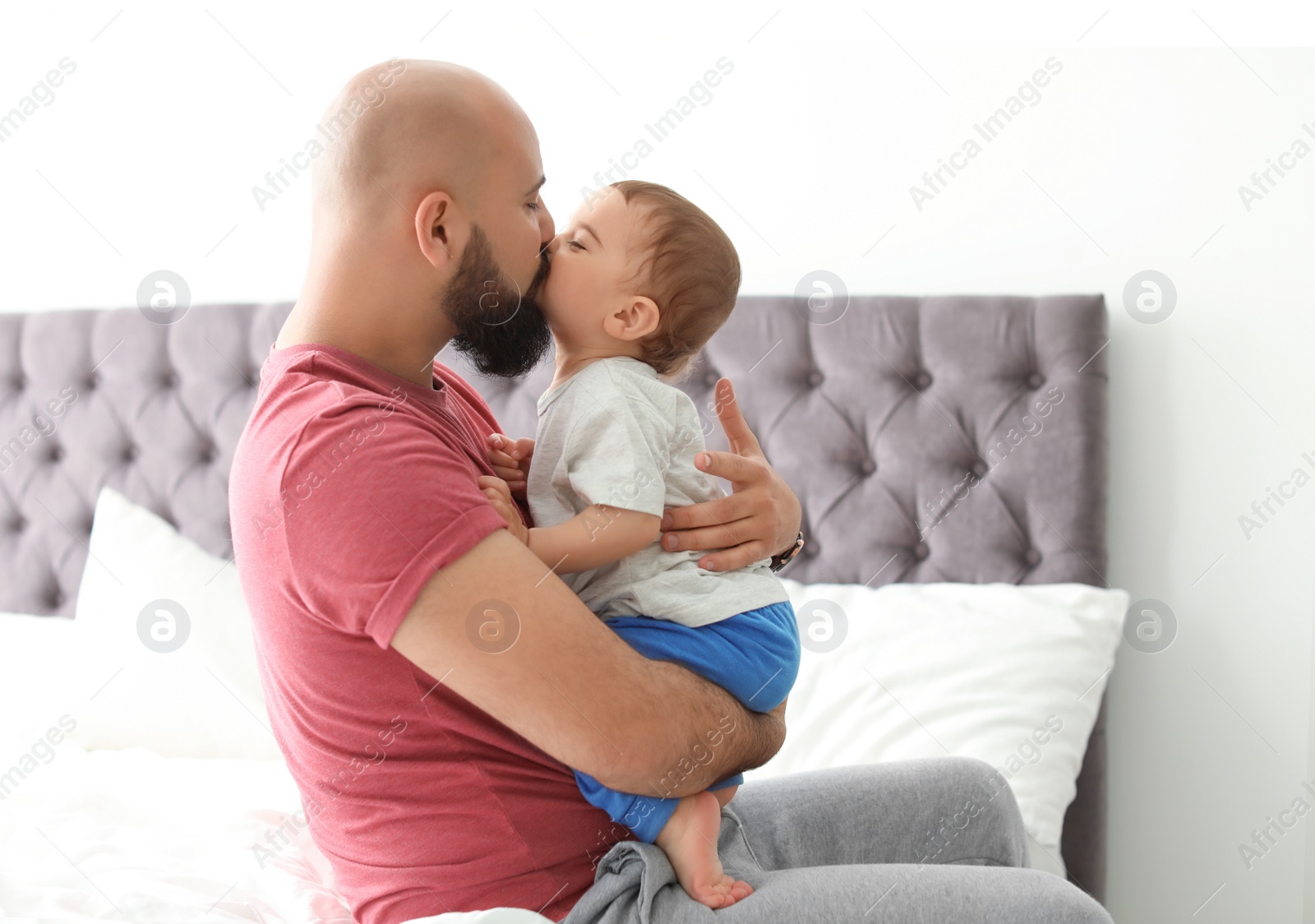 Photo of Dad and his little son spending time together at home