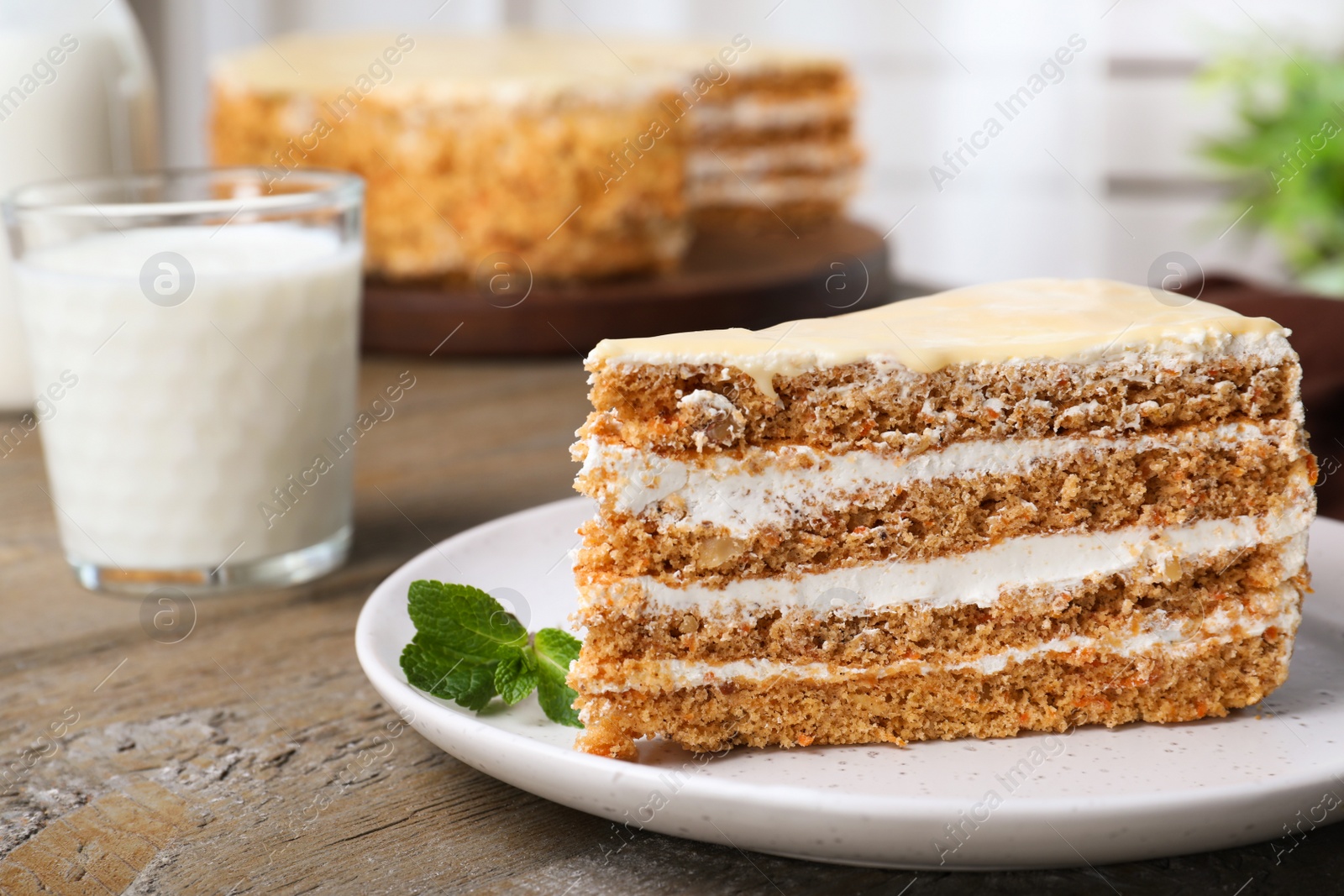 Photo of Delicious cake with condensed milk on wooden table, closeup