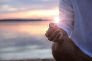 Photo of Man near river at sunset, closeup view with space for text. Nature healing power