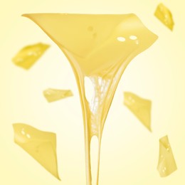 Slices of cheese falling on yellow background