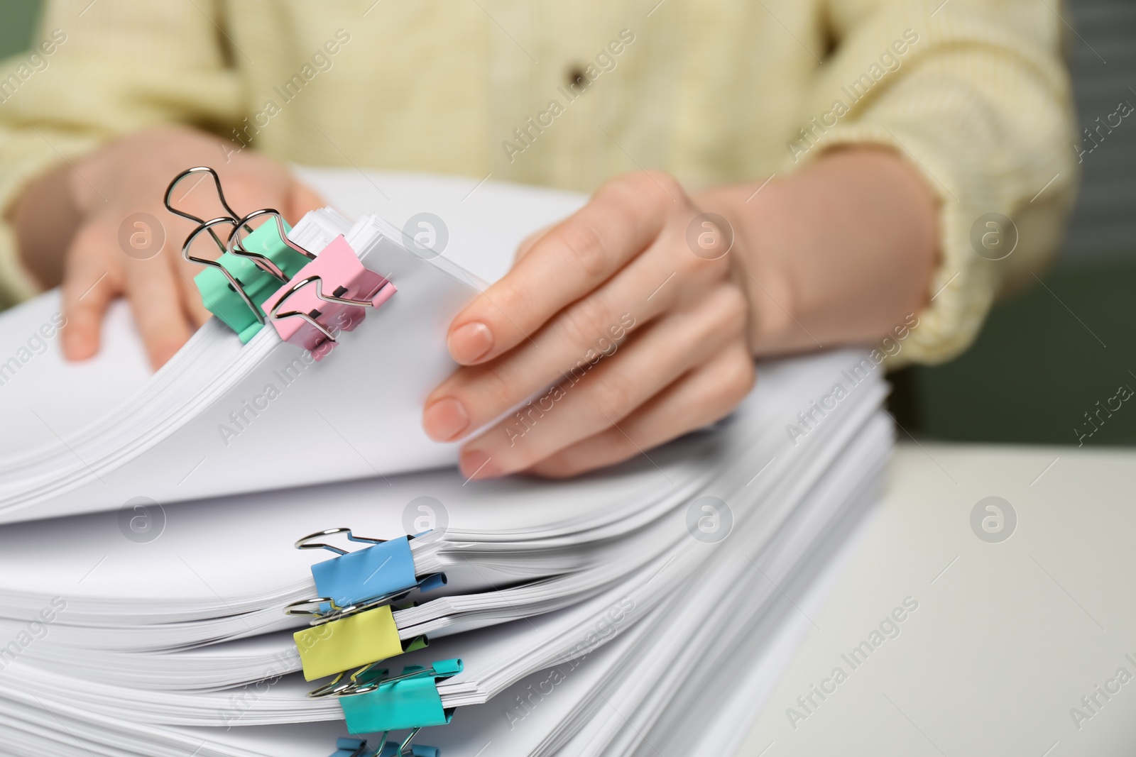 Photo of Woman working with documents at table in office, closeup