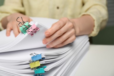 Woman working with documents at table in office, closeup