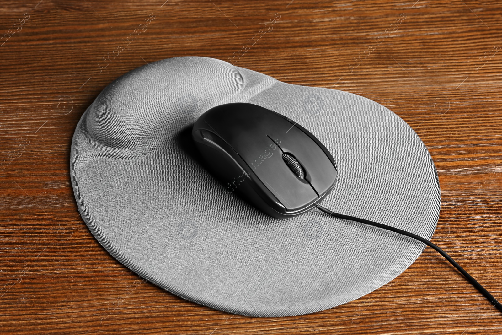Photo of Blank pad and computer mouse on wooden background