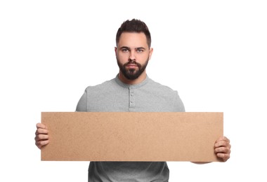 Photo of Young man holding blank cardboard banner on white background, space for text
