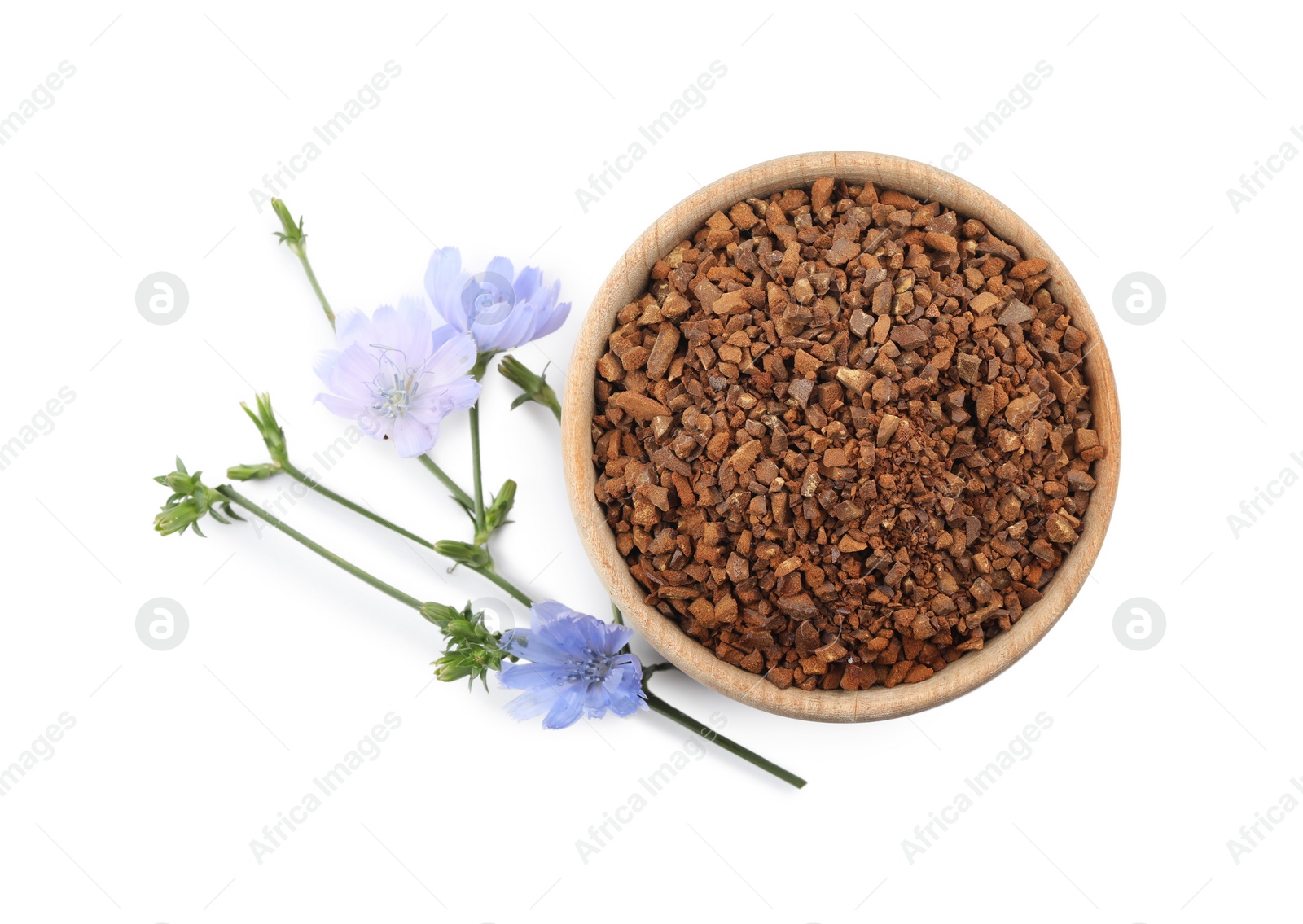 Photo of Bowl of chicory granules and flowers on white background, top view