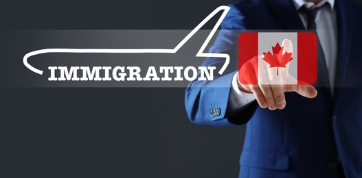 Image of Immigration. Businessman touching digital screen with illustration of airplane, word and flag of Canada on dark grey background, closeup
