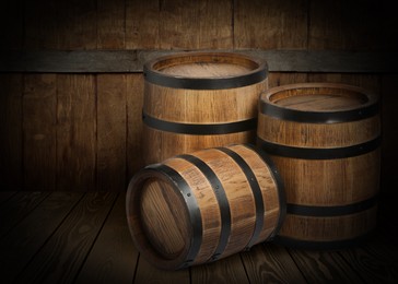 Barrels on wooden background, space for text