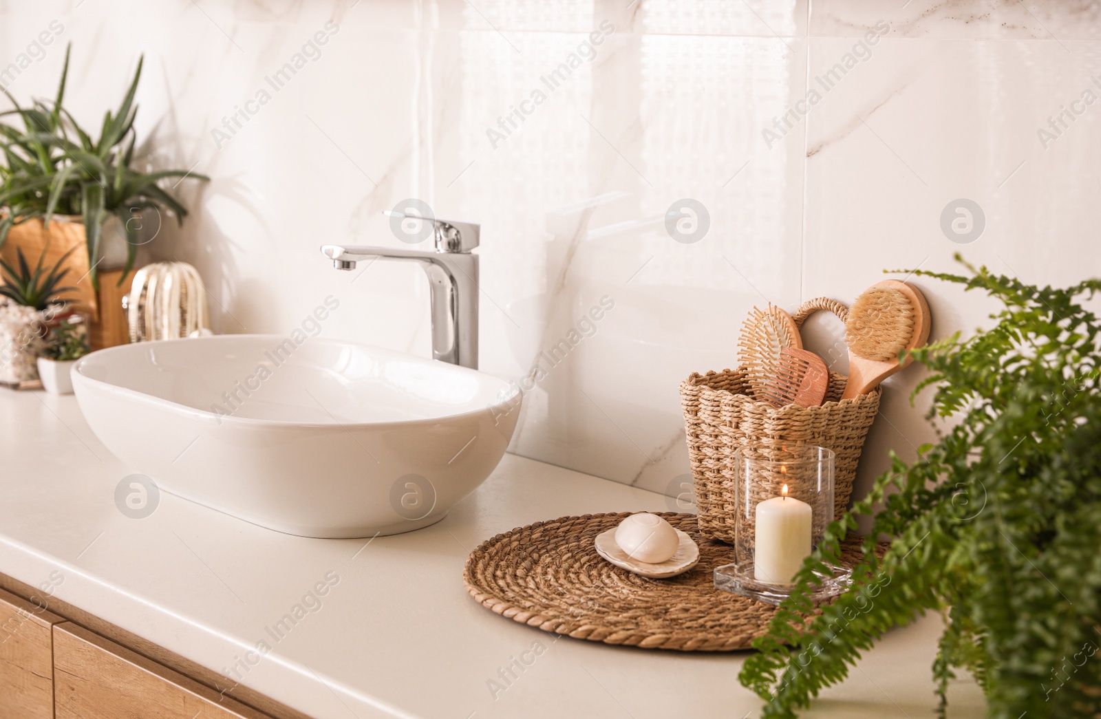 Photo of Countertop with sink and toiletries in bathroom. Interior design