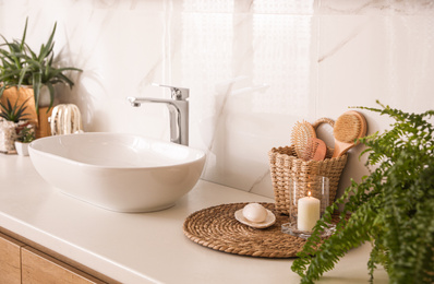 Countertop with sink and toiletries in bathroom. Interior design