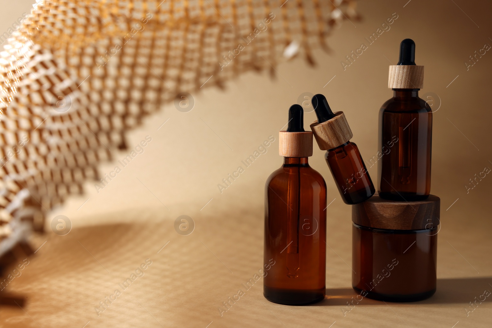 Photo of Set with different luxury cosmetic products on dark beige background, space for text