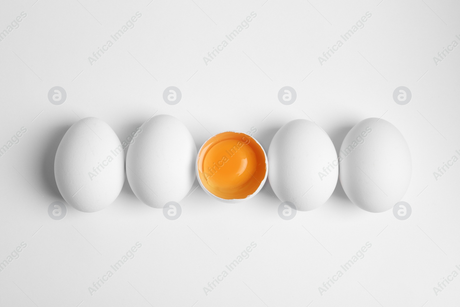 Photo of Fresh raw chicken eggs on white background, flat lay