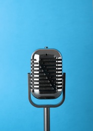 Retro old style microphone on color background