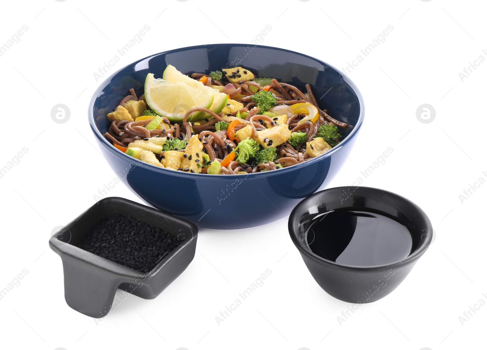 Photo of Stir-fry. Delicious cooked noodles with chicken in bowl, soy sauce and sesame on white background