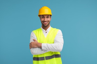 Photo of Engineer in hard hat on light blue background