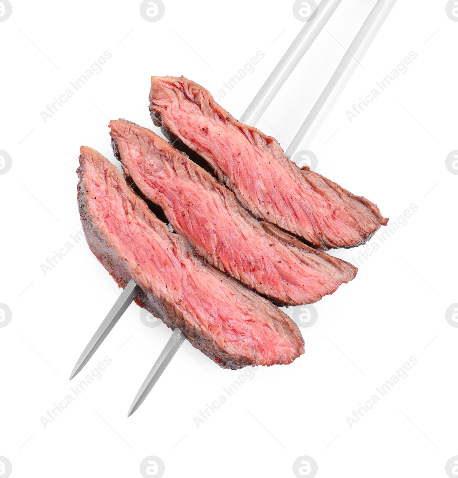 Photo of Meat fork with grilled beef pieces isolated on white, top view