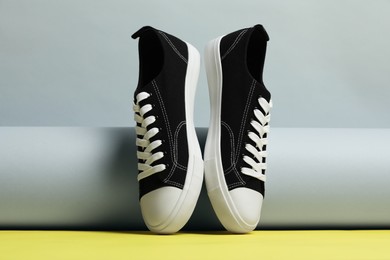 Photo of Pair of stylish sneakers on color background